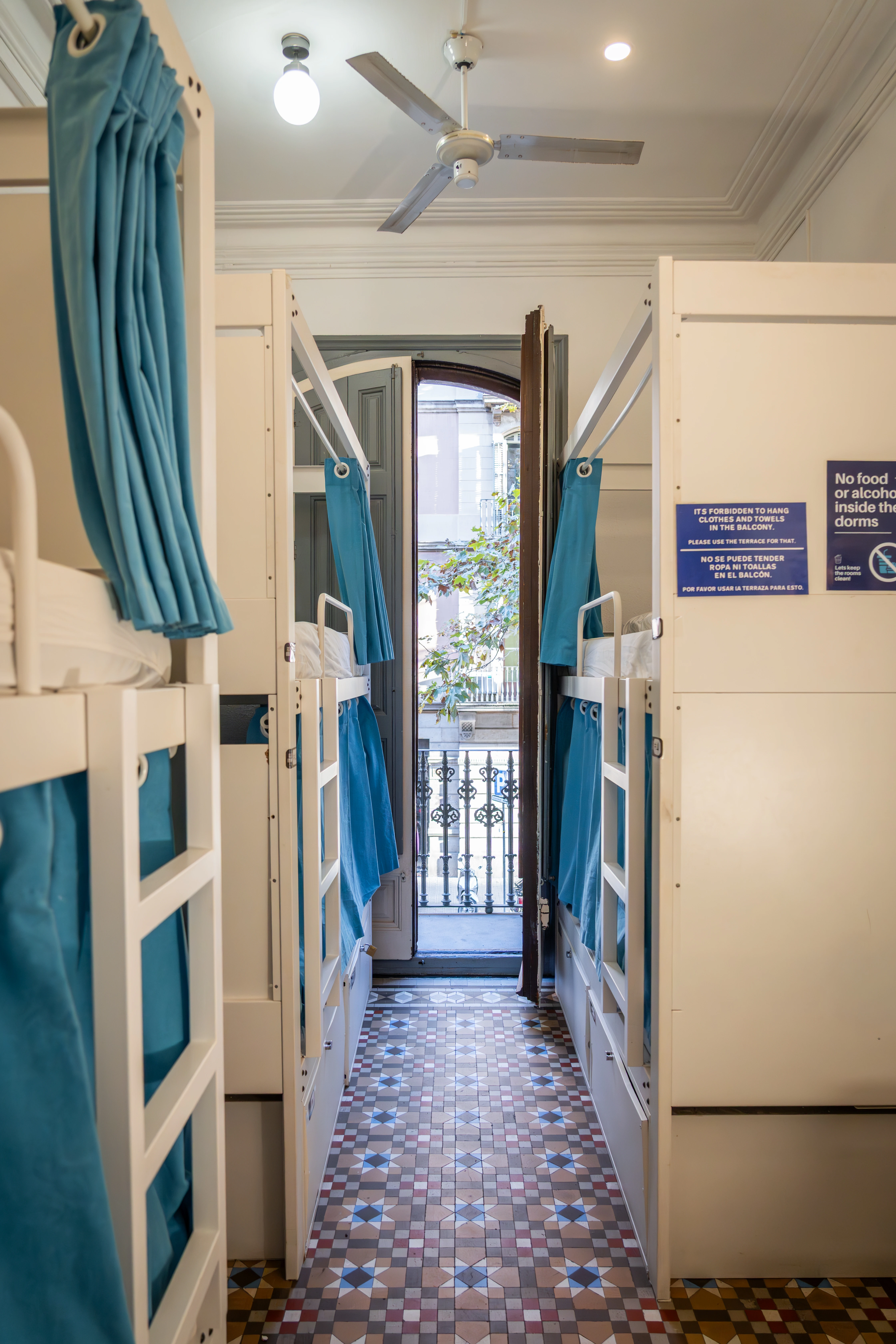 Bed and sockets detail in female room in Barcelona